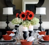 a traditional black and white Thanksgiving tablescape made bolder with red touches – bowls and blooms – looks cool and bright