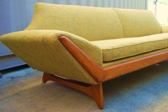 a yellow printed mid-century modern sofa with a rich-stained frame is a catchy and bold solution for a mid-century modern living room