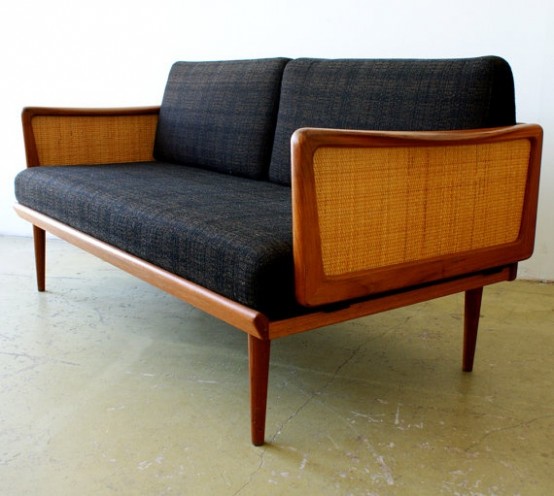 a mid-century modern sofa with a stained frame, rattan armrests and black upholstery will be a nice solution for both indoors and outdoors
