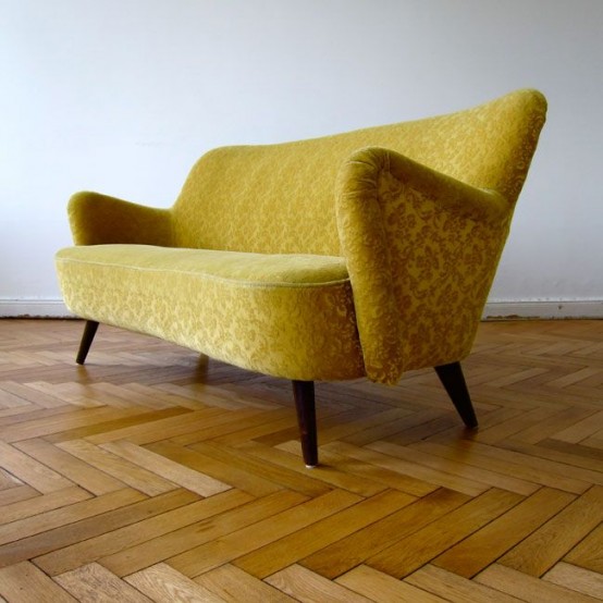 a mustard mid-century modern sofa with sculptural armrests is a bold and cool addition to a mid-century modern living room