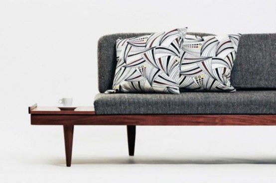 a grey mid-century modern sofa with an additional stained shelf coming out of the frame is a cool and functional idea