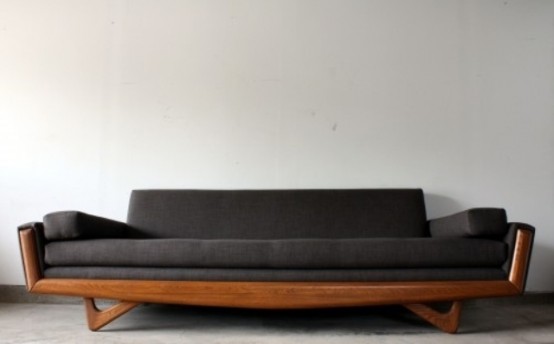 a black mid-century modern sofa with a stained frame is a stylish and practical solution for many spaces