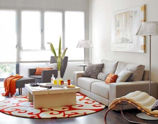 a vivacious small living room with neutral furniture and bright accents, a glazed wall, floor lamps and a large artwork