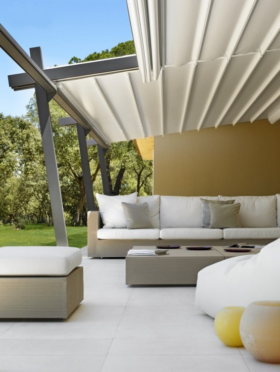 a minimalist neutral terrace with stained neutral furniture, a matching low coffee table and candle lanterns is amazing