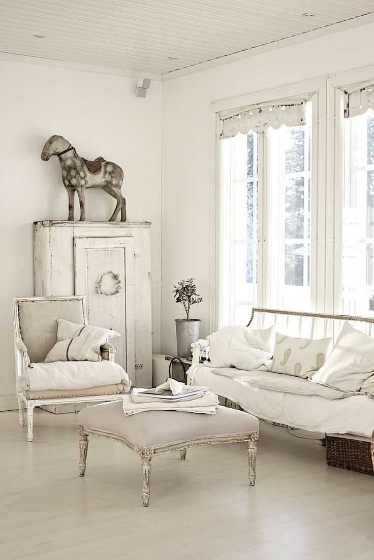 a beautiful neutral shabby chic living room with refined vintage furniture, a wardrobe and pretty and unusual decor
