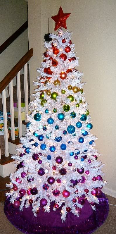 a white Christmas tree with colorful gradient ornaments in all the colors of rainbow is a bold and fun idea