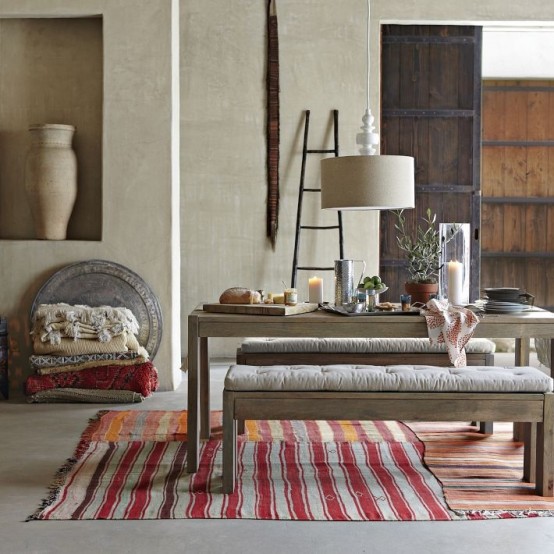 a modern Moroccan dining space with neutral furniture, bright textiles and linens and modern lamps and vases
