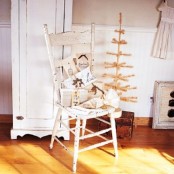 a white vintage chair with a pile of gifts wrapped into neutral paper is a chic vintage touch to your festive decor