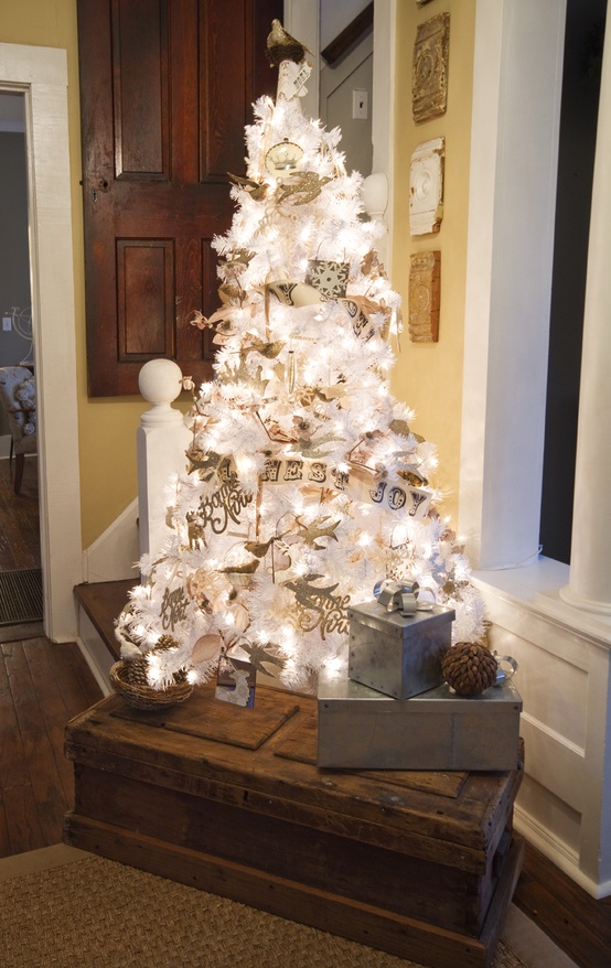 a lovely white vintage Christmas tree with lights and silver and white Christmas ornaments plus banners and calligraphy is wow