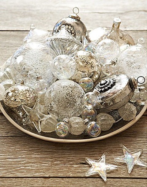 a Christmas centerpiece of a bowl with white and silver vintage ornaments is a refined touch to your holiday decor