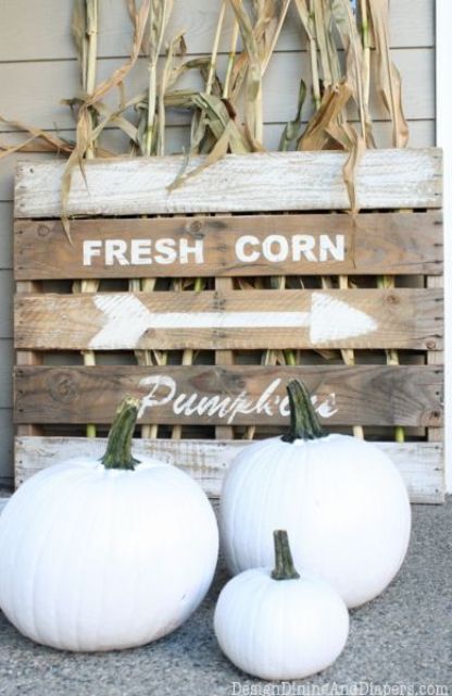 white pumpkins, a wooden pallet with husks can be used for decorating your outdoors in neutral shades