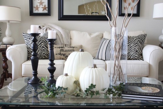 white pumpkins, white candles in black candleholders and greenery for a chic vintage-inspired coffee table display