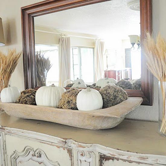 a dough bowl with moss balls and white pumpkins is a great all-natural decoration for the fall