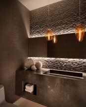 a geometric 3D concrete wall and a concrete floating sink add an edge to the bathroom