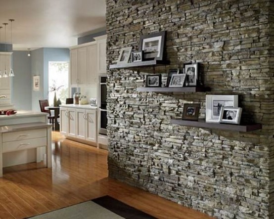 a textural stone accent wall adds interest and eye-cathciness to the vintage-inspired space in white and light blue