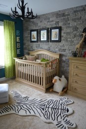 a faux stone wall adds a rustic feel to the nursery and is safe for kids and adults