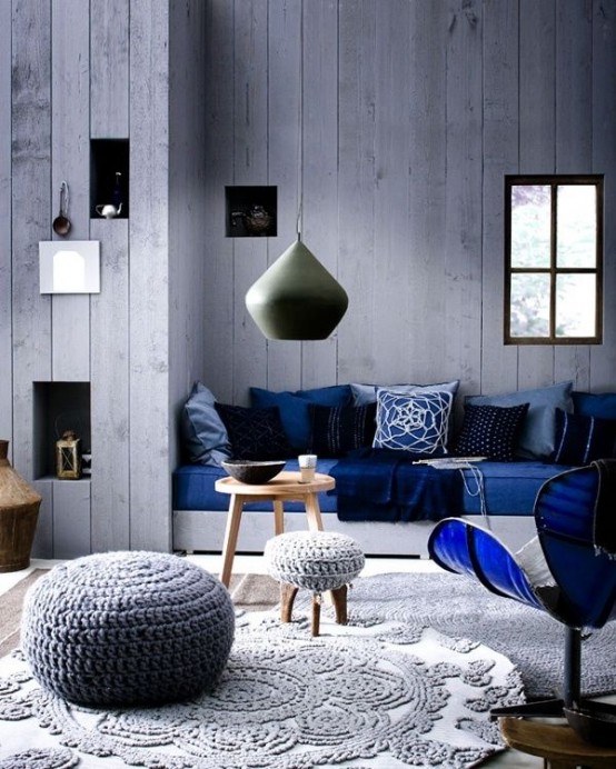 a whitewashed wooden wall makes the living room relaxed and adds somewhat a shabby feel to it