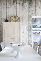 a shabby chic whitewashed wood plank wall makes the contemporary space more refined and gives it a character