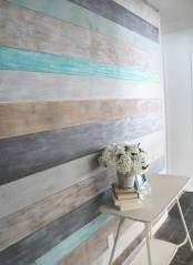a wall covered with shabby and washed out wood in planks of different colors – beige, white, grey and graphite grey