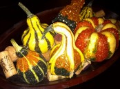 a bowl with faux pumpkins and wine corks is a simple and cool decoration for a coffee table