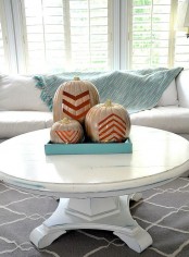 a turquoise tray with three white cutout chevron pumpkins is a simple and modern option for decor