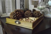 a tray with pinecones and wine corks is a simple rustic decoration for the fall or winter