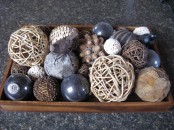 a tray with acorns, twine balls, sequin ornaments and navy glas sones for cozy fall home decor