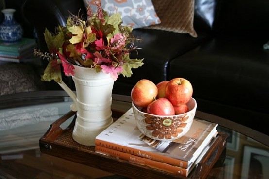 a bowl with apples and a jug with bright fall leaves will be a nice and natural fall coffee decoration
