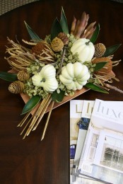 a fall arrangement of dried blooms, twigs, branches, leaves and white pumpkins is an easy option for the fall