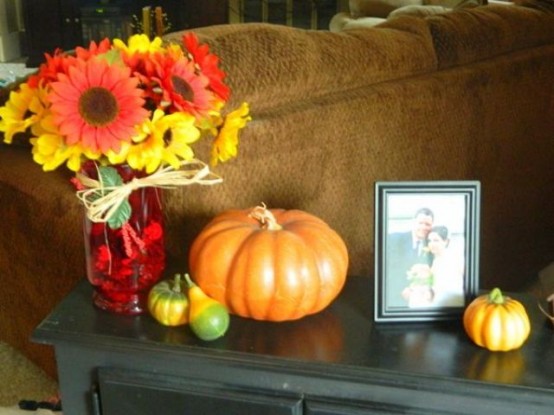 a bright fall flower arrangement with colorful fall pumpkins will be nice for styling your coffee table