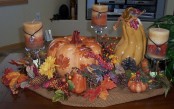 burlap, fake fall leaves, pumpkins,pinecones and berries plus fall-colored candles on each side