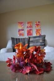 an arrangement of super bright faux fall leaves is all you need to bright a strong fall feel to the space