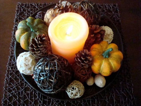 a bowl with pinecones, fresh and faux pumpkins, twine balls and candles for a centerpiece or for fall coffee table decor