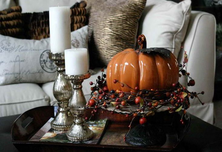 a tray with candles and a faux pumpkin with berries on a stand is a super cool idea for coffee table decor