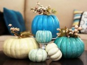 bright blue and turquoise pumpkins topped with faux berries and blooms are great bright fall decorations to rock