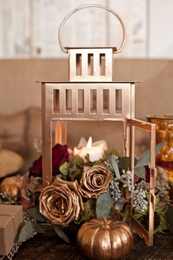 Spray paint pumpkins and roses with metallic them even more beautiful additions to a lantern centerpiece than they already are