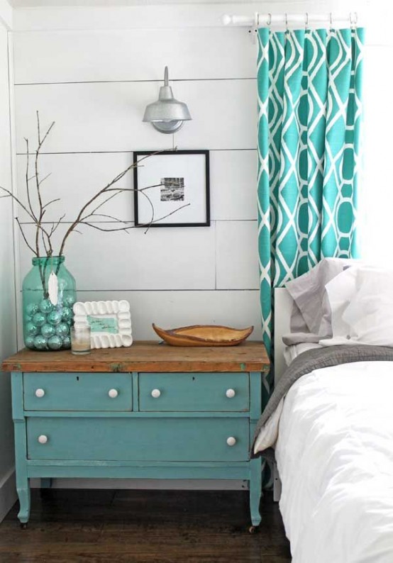 a vintage farmhouse bedroom with white plank walls, vintage furniture and turquoise accents