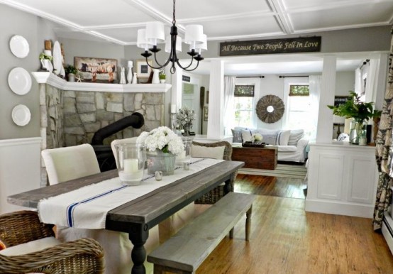 a vintage farmhouse dining area with a vintage wooden dining set, wicker and upholstered chairs, a retro chandelier