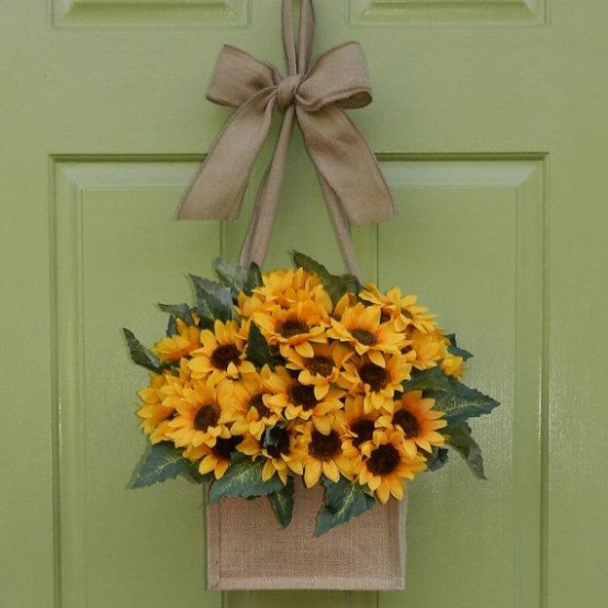 a fall arrangement of burlap and faux sunflowers and a taupe bow is a stylish idea for fall door decor