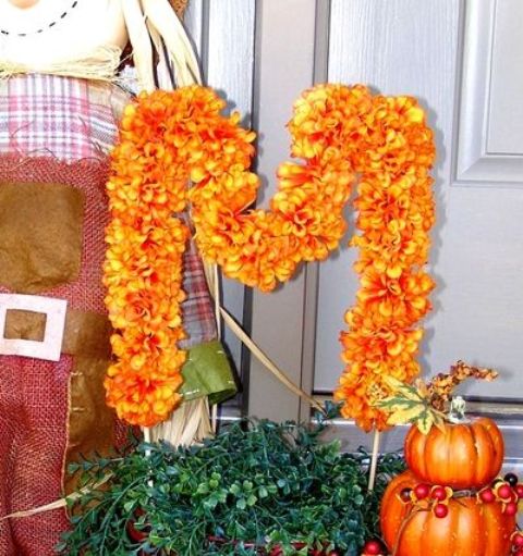 a bright orange faux flower monogram is a stylish decoration for the fall, make one for your home, too