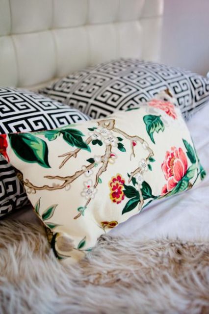 a bright floral pillow is a catchy and bold accent for any space, from the most neutral to the most colorful one