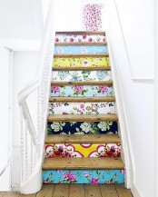 a staircase with colorful wallpaper touches including floral ones is a cool and bold decor idea for any space, add some color and pattern