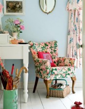 a bright floral pattern vintage chair, pastel floral print curtains and real blooms add chic and a refined feel to the space