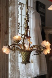 a whimsical floral chandelier with a basket and blooms that function as lights is a very chic idea