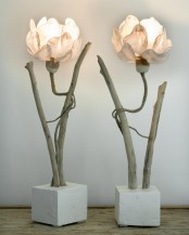 quirky floor lamps with concrete bases, wooden branches and flower-shaped pink lampshades are whimsical lights for your space
