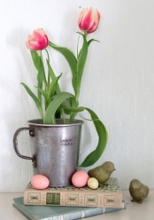 an oversized galvanized mug with some bright tulips is a pretty decoration for spring and Easter that you can make very fast