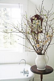 a vintage jug with blooming branches, faux or real ones, will be great to style a rustic or farmhouse space for spring