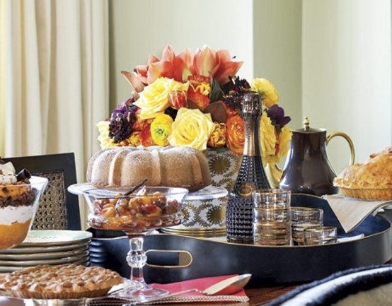 a bold Thanksgiving centerpiece of bright yellow and orange blooms and some dark ones is a lovely idea for the fall