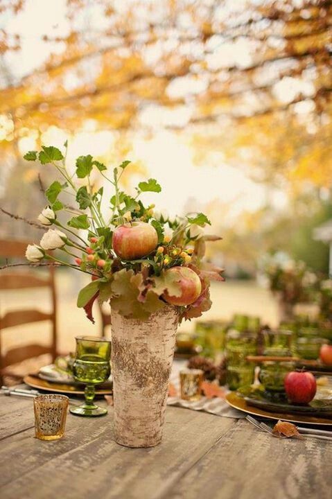 greenery, green glasses and plates, apples and bark make up a cozy woodland Thanksgiving tablescape