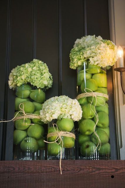 glass vases with green apples and white hydrangeas are amazing for Thanksgiving or fall decor in rustic style